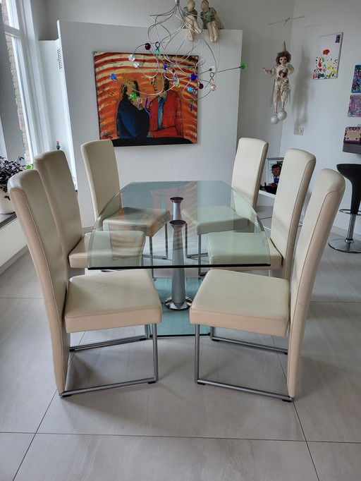 Dining room table glass + 6 chairs cream/white leather. Brand Rolf Benz price 850,00€.