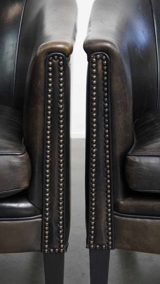 Image 1 of  Set van 2 subtiele zwart/ grijze schapenleren clubfauteuils 