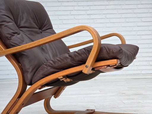 Fauteuil danois des années 1970 de la marque Komfort, cuir, toile et bois courbé.