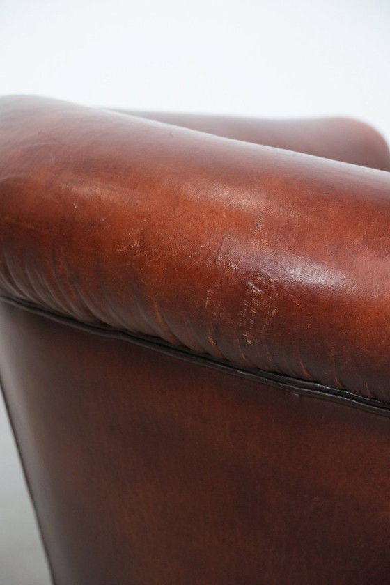 Image 1 of Vintage clubfauteuil gemaakt van schapenleer met siernagels