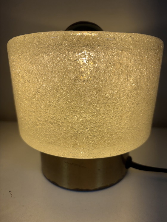 Image 1 of vintage table lamp by Peill & Putzler is made of thick ice glass with brass details
