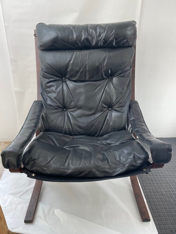 Image 1 of Siesta armchair and footrest in black leather and mahogany wood
