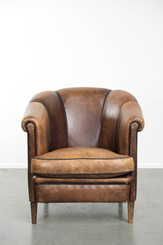 Image 1 of Leuke vintage schapenleren clubfauteuil in Engelse stijl met zwarte biezen