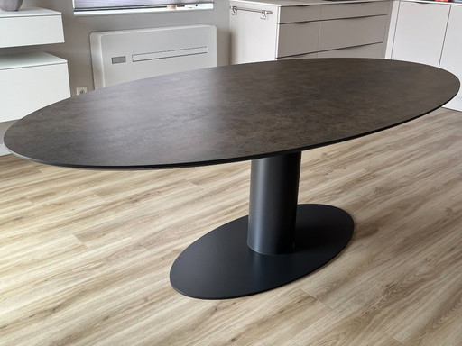 Preciosa mesa de comedor ovalada Metaform con tablero de cerámica Orfis.