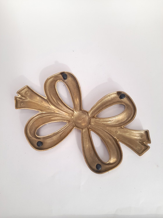 Image 1 of Salvamanteles de latón con doble nudo