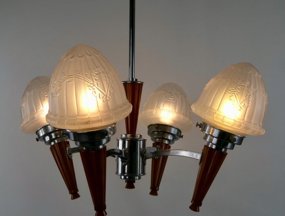 Image 1 of Chrome Art Deco chandelier with four amber Bakelite torches with decorated glass lampshades, ca. 1935