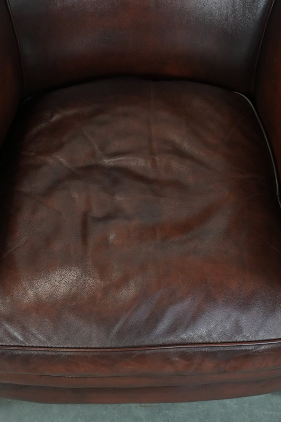 Image 1 of Sillón club de piel de vaca en buen estado, de un lujoso color rojo/marrón.