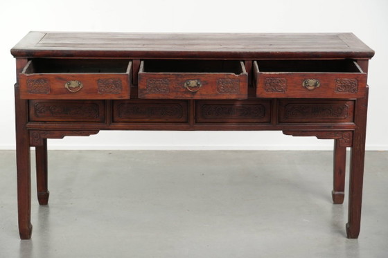 Image 1 of Antique wooden Chinese sideboard from the late 19th century in a beautiful red color with exquisite wood carving.