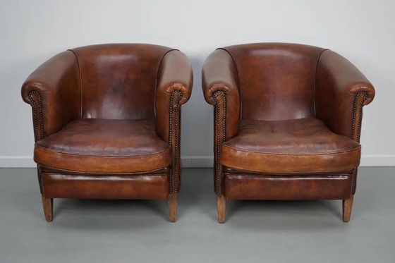 Image 1 of Vintage Nederlandse leren clubfauteuils in cognackleur, set van 2 met voetenbank