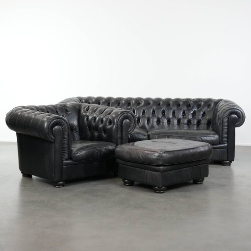 Set consisting of a black Chesterfield sofa, armchair and footstool made of cowhide