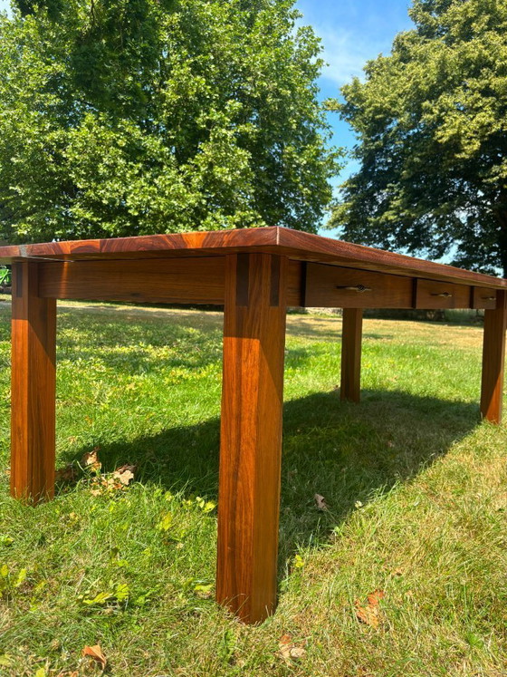 Image 1 of Dining table in American walnut and maple. Handcrafted solid wood extensions and drawers. Live edge for visual depth. Epoxy resi