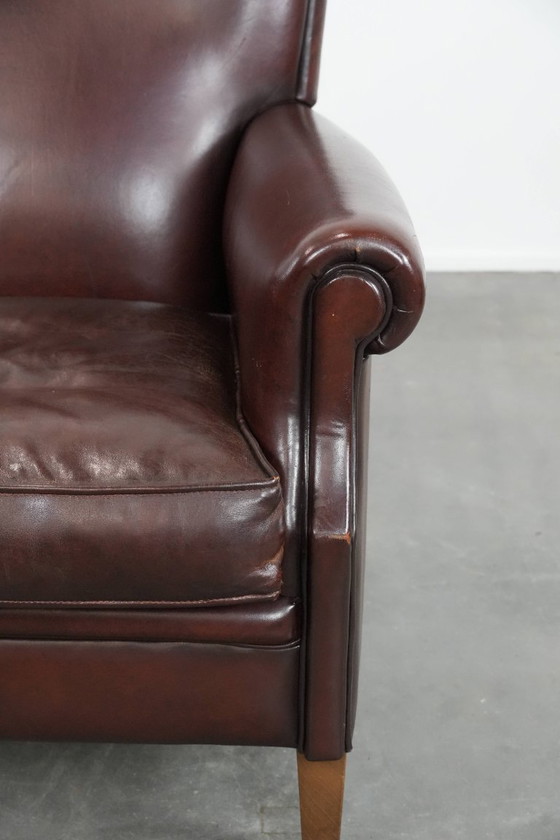 Image 1 of Donkere luxe schapenleren fauteuil/ armchair met een tijdloze uitstraling