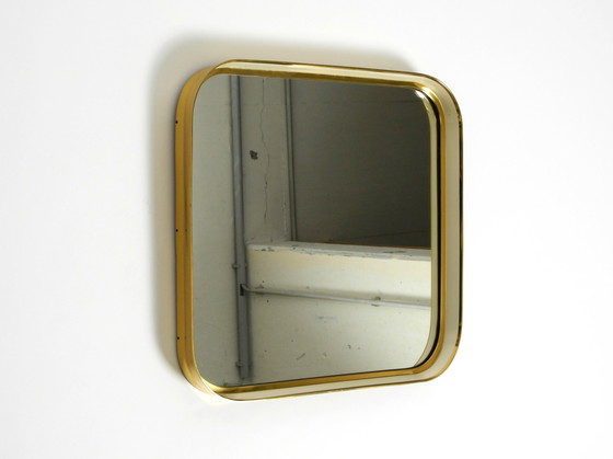 Image 1 of Prachtige originele Mid Century Moderne "Zier-Form" wandspiegel met zware messing lijst door "Münchener Zierspiegel".