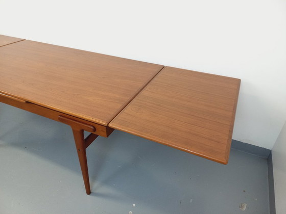 Image 1 of Vintage Scandinavian rectangular dining table by Ejvind A. Johansson from the 50s and 60s in teak with integrated extensions