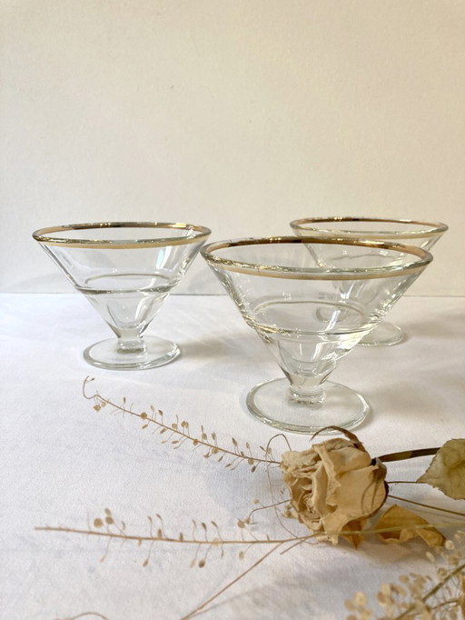 Trio of glass dessert bowls with gold rims, La Rochère, France