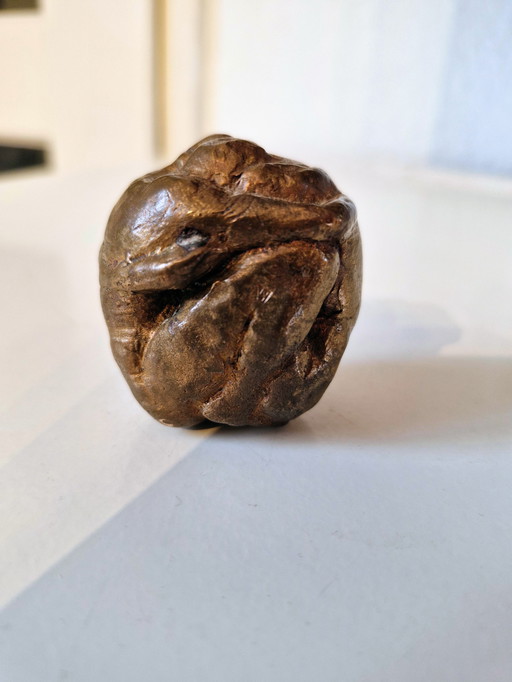 Solid small bronze statuette of two figures stamped into each other.