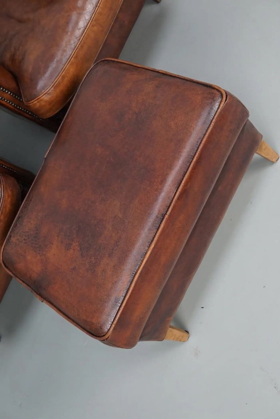 Image 1 of Vintage Nederlandse leren clubfauteuils in cognackleur, set van 2 met voetenbank