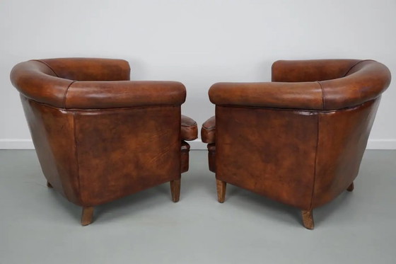Image 1 of Vintage Nederlandse leren clubfauteuils in cognackleur, set van 2 met voetenbank