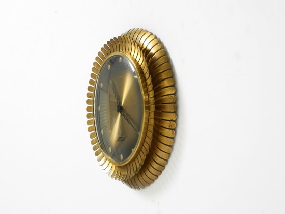 Image 1 of Beautiful original Mid Century Sunburst Atlanta Universe wall clock made of heavy brass with a mechanical seven-day movement
