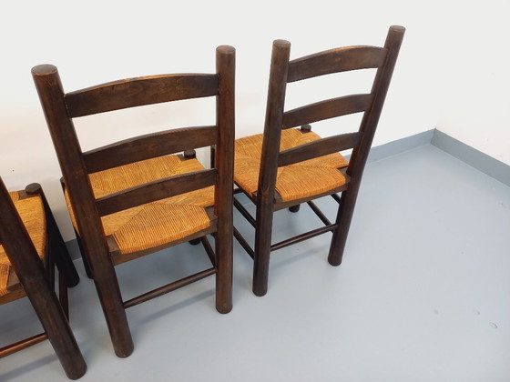 Image 1 of Set van 4 vintage brutalistische stoelen van Georges Robert, gemaakt van hout en stro, uit de jaren 50 en 60.