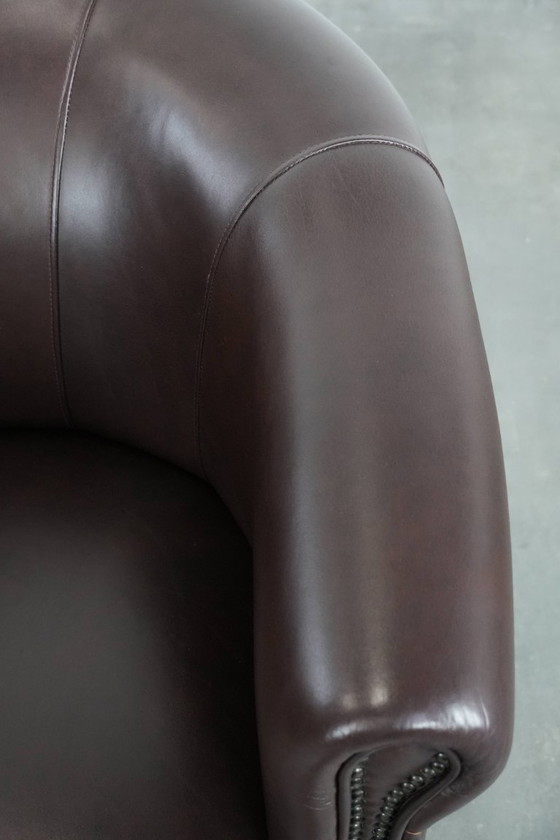 Image 1 of Cowhide club armchair, in very good condition, English style in a brown/dark purple color scheme