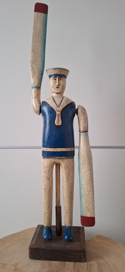 Antique sailor with oars for arms