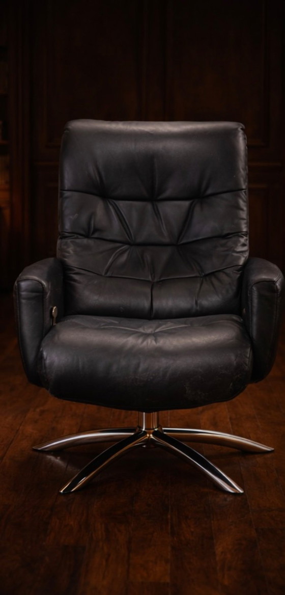 Image 1 of Modernist black leather armchair with a chrome X-frame base in a contemporary style, in good condition with minor signs of aging