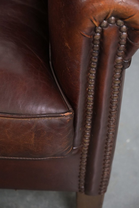 Image 1 of Vintage clubfauteuil gemaakt van schapenleer met siernagels