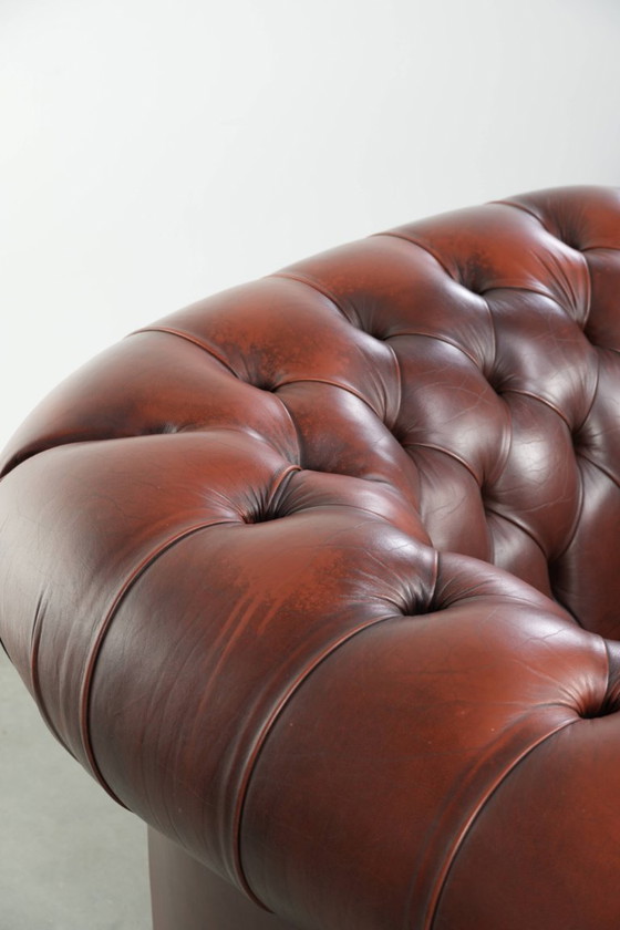 Image 1 of Beautiful red/brown cowhide Chesterfield armchair in a classic English style
