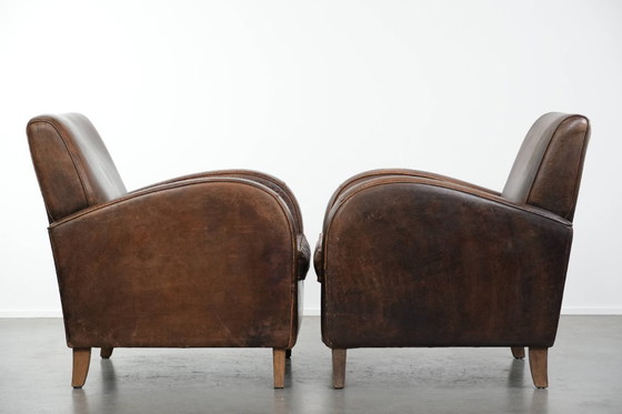 Image 1 of 2 x Vintage schapenleren design fauteuil in een donkere cognac kleur
