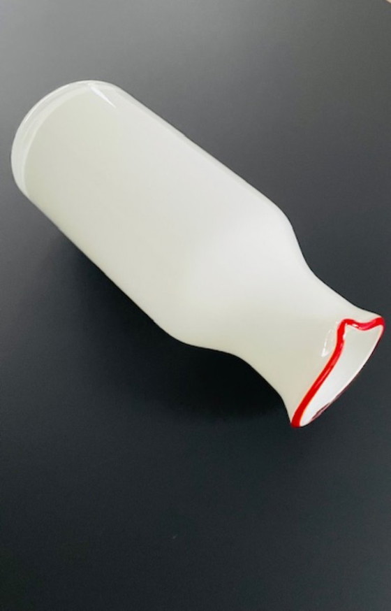 Image 1 of Caraffa dal design scandinavo in vetro bianco con bordo rosso.