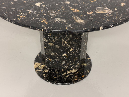 Exclusive design table made of black marble - round with facetted base, timeless