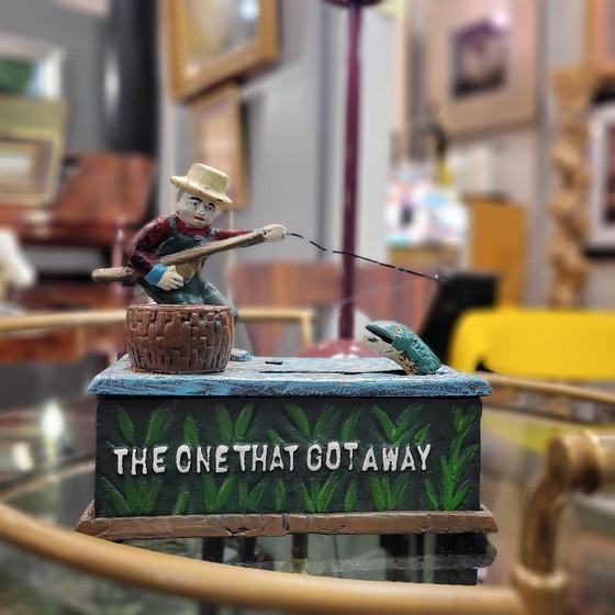 Image 1 of "Fisherman" piggy bank with fishing mechanism, cast iron, 1950s - USA.