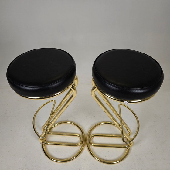Image 1 of two bar stools, distinguished by their clean lines, high-quality craftsmanship, and timeless elegance.