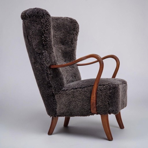 Fauteuil danois des années 1960, retapissé, peau de mouton véritable.