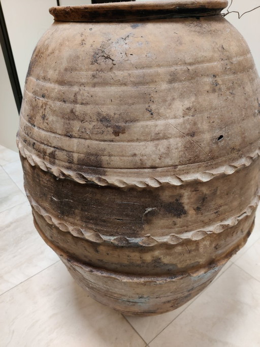 Large antique terracotta pot with a red tint
