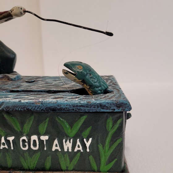 Image 1 of "Fisherman" piggy bank with fishing mechanism, cast iron, 1950s - USA.