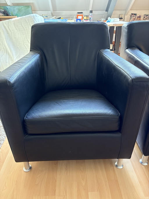 2x black leather armchairs