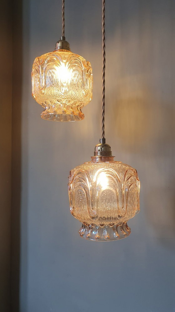 Image 1 of Set of 2 Vintage textured rose / amber tinted pendant lamps - mid-century design.