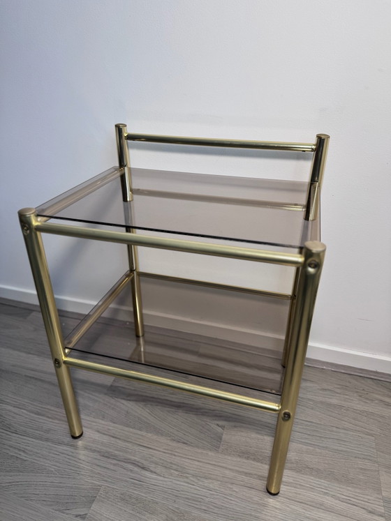 Vintage Regency stule  two-tier side table or nightstand featuring a brass-finished metal frame and smoked (photo 10 of 14)
