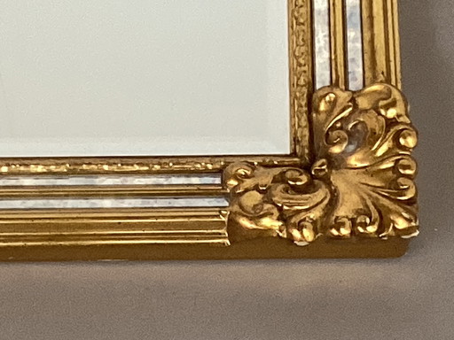 Gilded Deknudt facet mirror with fume edges
