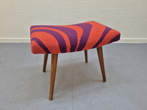 Vintage footstool with graphic print in orange/purple.
