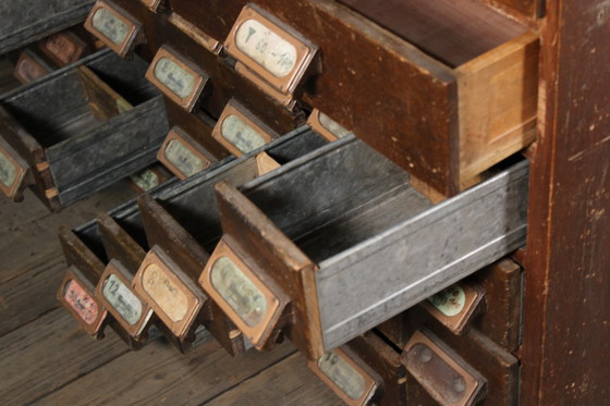 Image 1 of Antique industrial apothecary cabinet • Vintage wood and metal drawer cabinet with many compartments