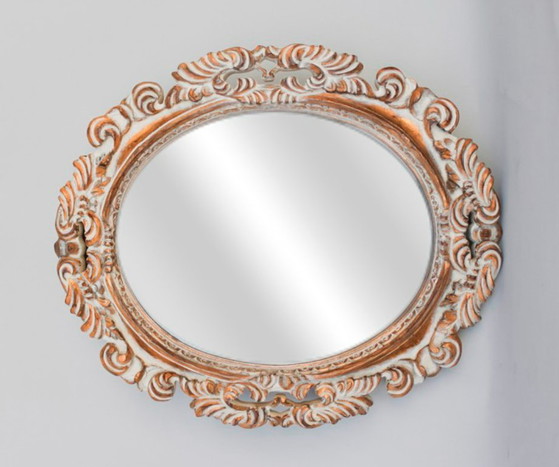 Image 1 of Oval mirror, gilded and carved from wood. Decorated and distressed with scrolls and leaves. Exclusively handmade by artisans.