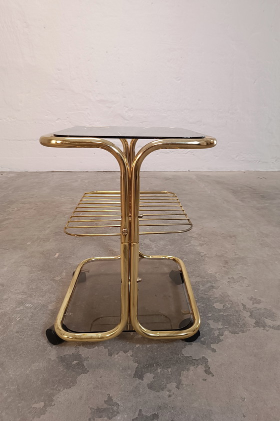 Image 1 of Vintage gold coloured and glass trolley side table 