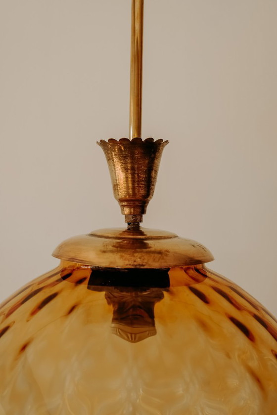 Brass Pendant Lamp with Round Orange Glass Shade and Swirl Structure (photo 5 of 8)