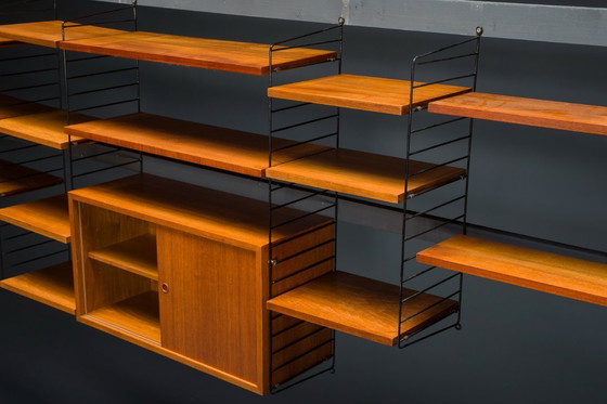 Image 1 of Modulaire wandplank in teak van Nils Strinning voor String, 1960, set van 29