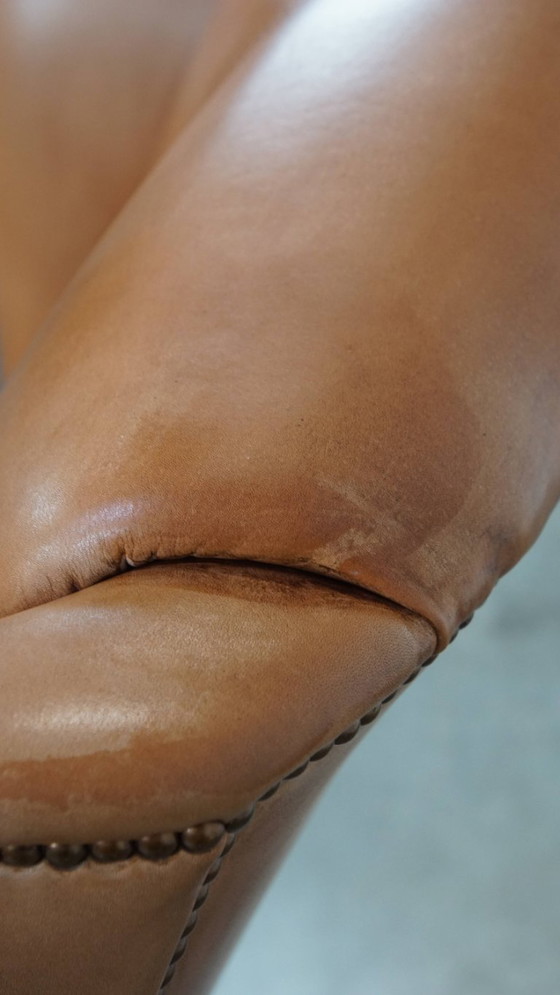 Image 1 of Oorfauteuil gemaakt van rundleer afgewerkt met siernagels