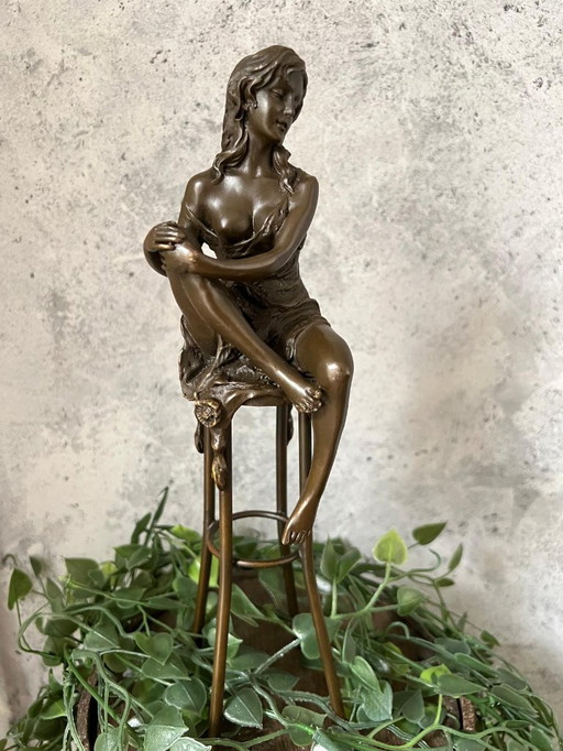 Bronze lady on chair