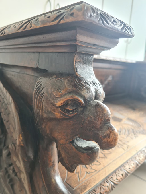 Wooden bench with hand-carved figures